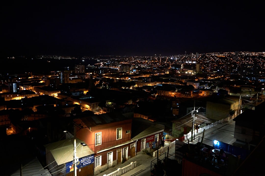 Documentary photographer walking through a colorful Chilean hillside neighborhood