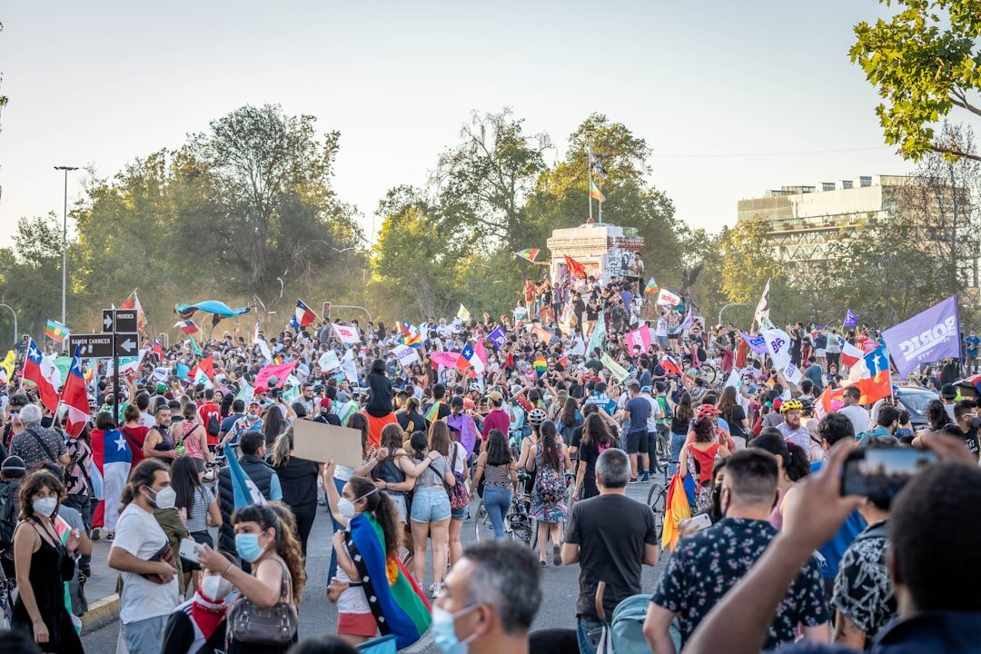Local community members gathered talking outdoors in a Chilean town square