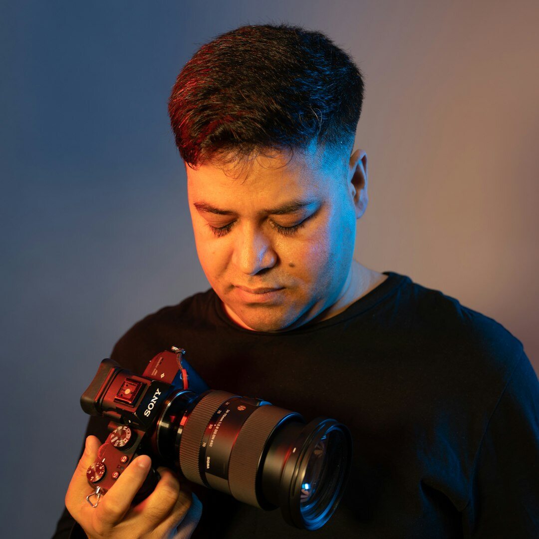 Portrait of a Chilean documentary photographer holding a camera